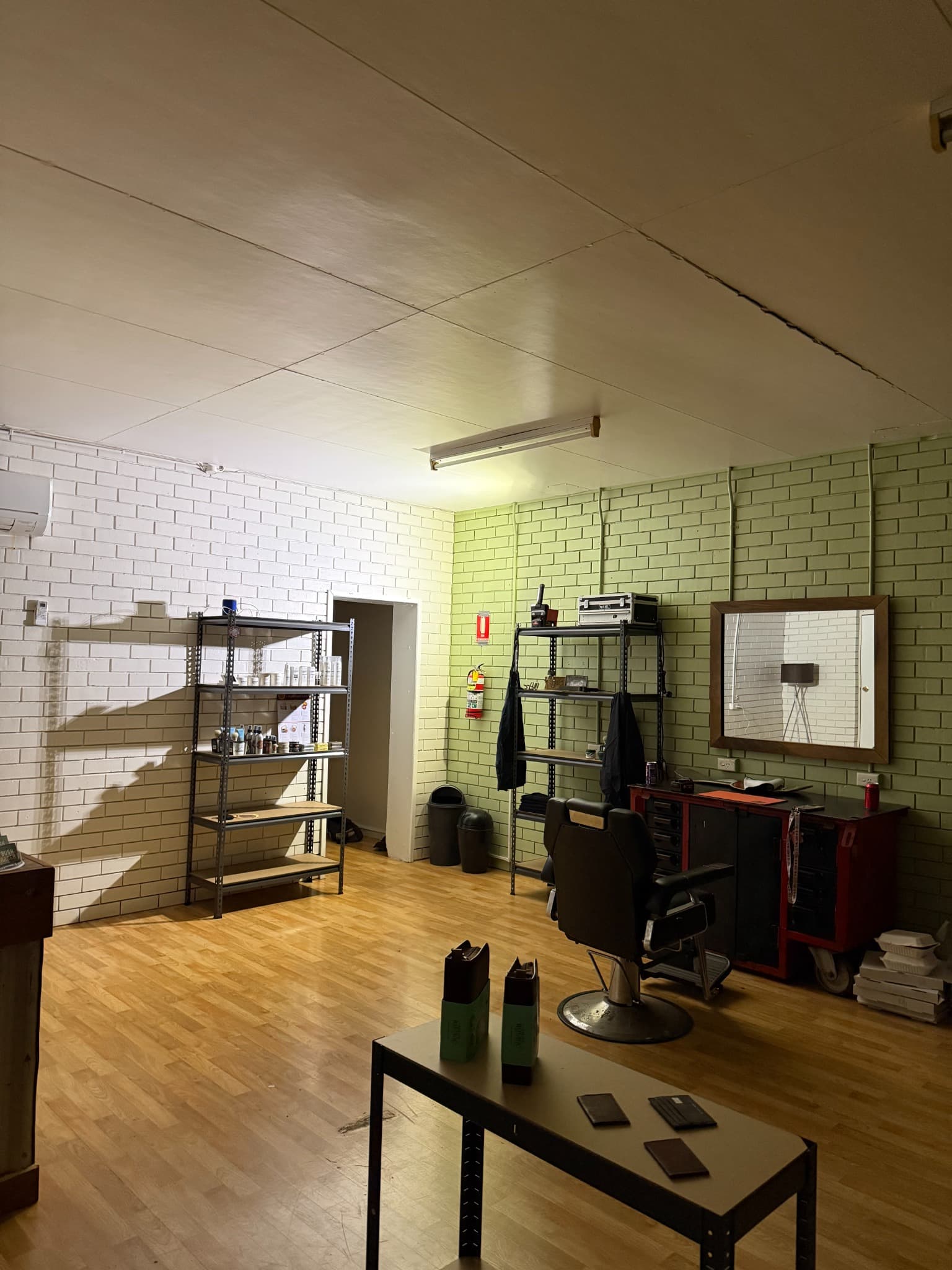 The barber chair and product shelves inside Bush Barber